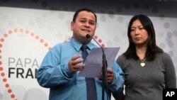 Joao Batista, left, and Lucila Yurie, from Brazil, deliver a statement at the Fatima Sanctuary, May 11 2017, in Fatima, Portugal. Batista and Yuri are the parents of a boy whose surprise recovery from a severe brain injury was used by the Vatican to make two Portuguese children saints.
