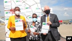 Tanzanian officials and US Ambassador to Tanzania Donald Wright at Julius Nyerere International Airport receive a consignment of COVID-19 vaccine, donated by the US, shipped by Emirates through the AU COVAX facility.
