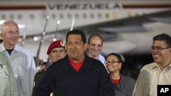 Venezuela's President Hugo Chavez (C) gestures after his arrival from Cuba, at Simon Bolivar International Airport in Caracas, July 23, 2011 (this image has been supplied to Reuters by a third party)