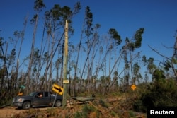 A search-and-rescue team from 50 Star Search and Rescue works amid debris from Hurricane Michael in Fountain, Florida, Oct. 18, 2018.