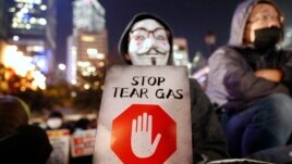A protester holds a sign reading 
