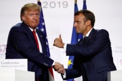 French President Emmanuel Macron and U.S President Donald Trump shake hands during the final press conference during the G7 summit Monday, Aug. 26, 2019 in Biarritz, southwestern France.