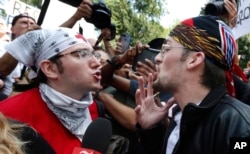 A counterprotester, left, confronts a professed supporter of President Donald Trump at a "Free Speech" rally by conservative activists on Boston Common, Aug. 19, 2017, in Boston.