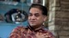 FILE - Ilham Tohti, an outspoken scholar of China's Turkic Uighur ethnic minority, speaks during an interview at his home in Beijing, China.