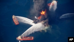 FILE - The Deepwater Horizon oil rig burns in the Gulf of Mexico following an explosion that killed 11 workers and caused the worst offshore oil spill in the nation's history, April 21, 2010.