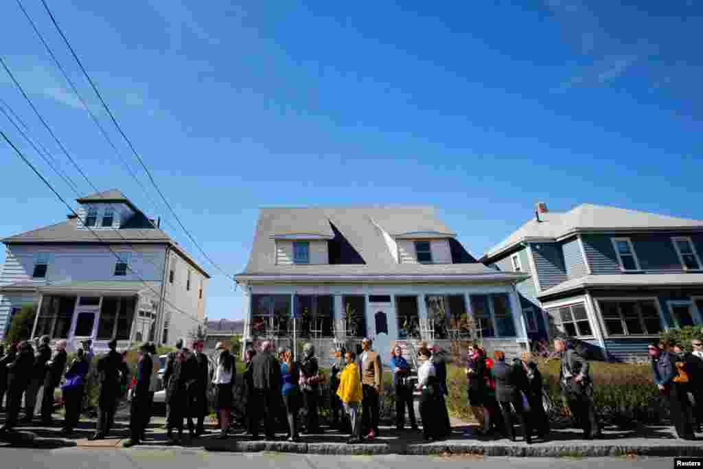 Hundreds of people wait in a line that extends around the block to pay their respects to the family of Krystle Campbell, April 21, 2013.