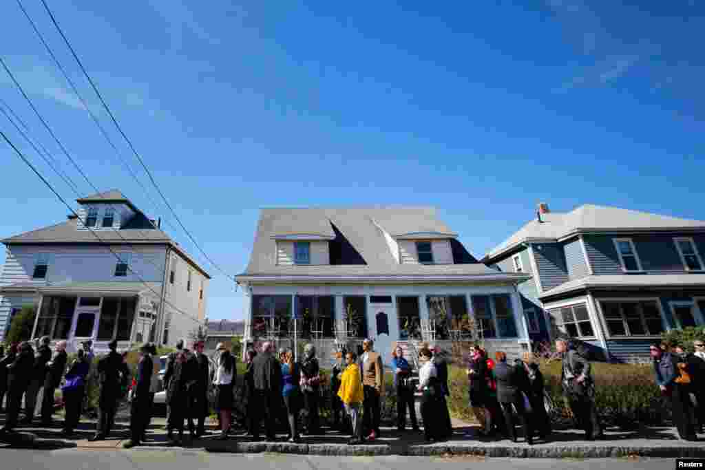 Hundreds of people wait in a line that extends around the block to pay their respects to the family of Krystle Campbell, April 21, 2013. 