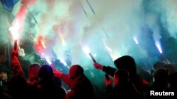 Activists of opposition parties burn flares during a rally demanding to break an agreement with Russia on the use of the Azov Sea and the Kerch Strait, in front of the parliament building in Kiev, Ukraine November 26, 2018.