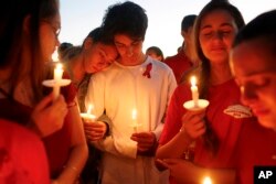 Students gather during a vigil at Pine Trails Park for the victims of the Wednesday shooting at Marjory Stoneman Douglas High School, in Parkland, Fla., Feb. 15, 2018.