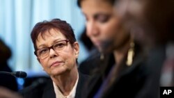 FILE - Human rights activist and independent journalist Miriam Leiva of Havana watches fellow witnesses during a hearing on Cuba on Capitol Hill in Washington, Feb. 3, 2015. 