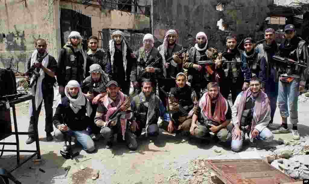 This photo shows Free Syrian Army fighters posing for a group photograph, exhausted and worn out from a year-long siege, before leaving Homs, May 7, 2014.