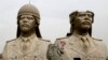 FILE - U.S. Army soldiers stroll past two bronze busts of former Iraqi president Saddam Hussein in the Green Zone in Baghdad, March 20, 2009, the sixth anniversary of the U.S.-led invasion of Iraq.