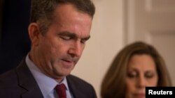 Virginia Governor Ralph Northam, accompanied by his wife Pamela Northam, announces he will not resign, during a news conference in Richmond, Virginia, Feb. 2, 2019.