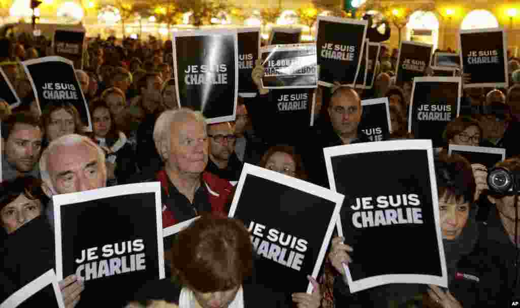 People hold posters reading &quot;I am Charlie&quot; as they gather to express solidarity with those killed in an attack at the Paris offices of the weekly paper Charlie Hebdo, in Nice, southeastern France, Jan. 7, 2015.
