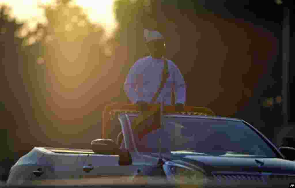 Myanmar President Thein Sein rides in an open vehicle inspecting officers and military hardware during a ceremony to mark Myanmar's 67th anniversary of Independence Day in Naypyitaw, Myanmar, Sunday, Jan. 4, 2015. (AP Photo/Gemunu Amarasinghe)