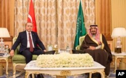 FILE - Turkish President Recep Tayyip Erdogan (L) and Saudi King Salman bin Abdul Aziz al-Saud pose for a photo during their meeting in Riyadh, Saudi Arabia, in this picture released, Dec. 29, 2015 by the office of the Saudi Press Agency.