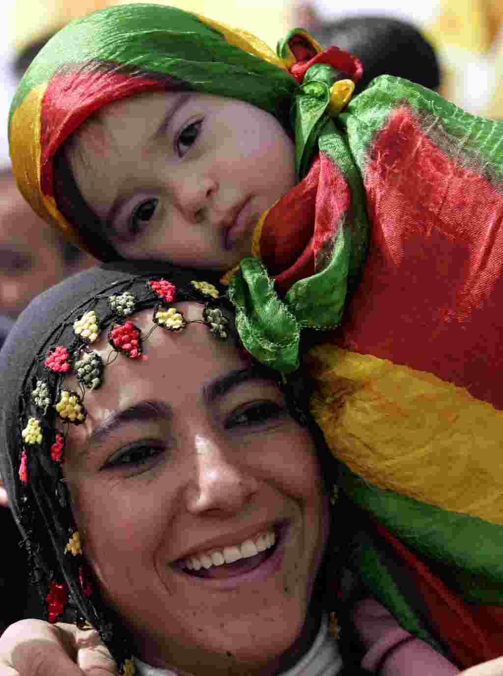 A Turkish Kurdish woman dances with her daughter during a gathering to mark the spring festival of Nowruz in Istanbul, Turkey, Wednesday, March 21, 2007. Tens of thousands of Kurds celebrated the spring festival of Nowruz traditionally used to assert sepa