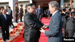 South Korean President Moon Jae-in shakes hands with North Korean leader Kim Jong Un during their summit at the truce village of Panmunjom, North Korea, May 27, 2018.