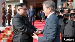 South Korean President Moon Jae-in shakes hands with North Korean leader Kim Jong Un during their summit at the truce village of Panmunjom, North Korea, May 27, 2018.