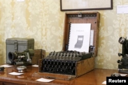 An Enigma cipher machine is on display among other wartime memorabilia pieces at an auction house in Bucharest, Romania, July 11, 2017.