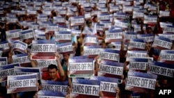 Activists hold a protest in front of the Chinese Consular Office in Manila as the country commemorates the 117th anniversary of the Philippines' declaration of independence from Spain, June 12, 2015.