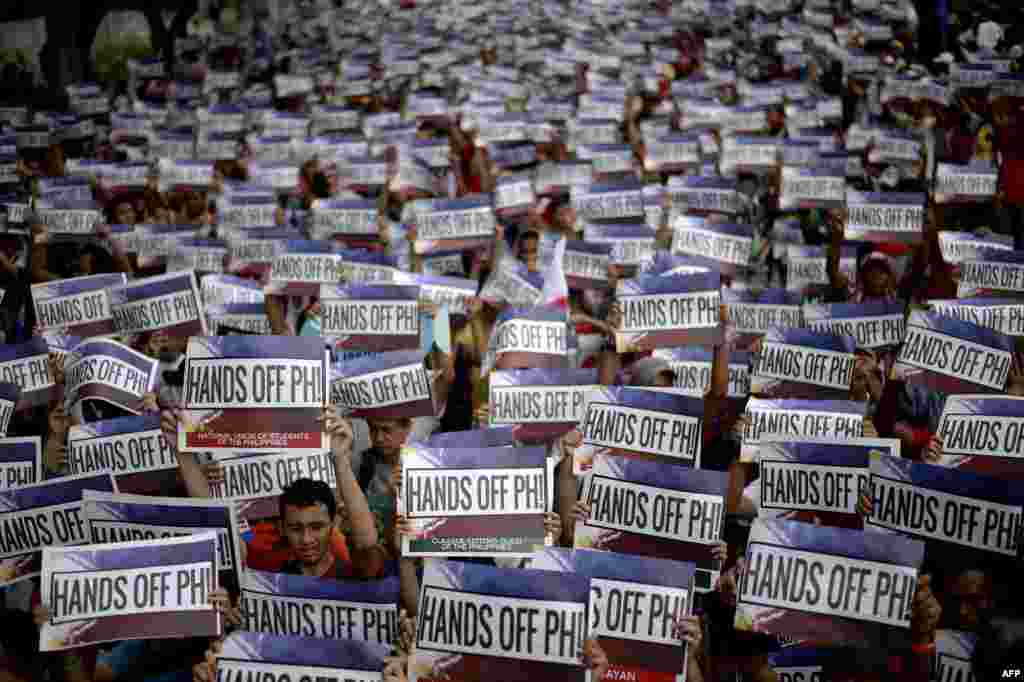 Activists hold a protest in front of the Chinese Consular Office in Manila as the country commemorates the 117th anniversary of the Philippines&#39; declaration of independence from Spain. Protesters shouted slogans against China&#39;s reclamation and construction activities on islands and reefs in the Spratly Group of the South China Sea that are also claimed by the Philippines.