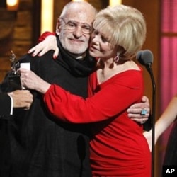 Larry Kramer, left, is hugged by Daryl Roth after they won the Tony Award for Best Revival of a Play for "The Normal Heart" during the 65th annual Tony Awards, June 12, 2011 in New York.