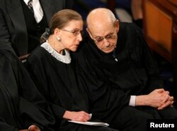 FILE - U.S. Supreme Court Associate Justices Ruth Bader Ginsburg and Stephen Bryer chat before then-President Barack Obama's address to a joint session of Congress on Capitol Hill in Washington, Feb. 24, 2009.