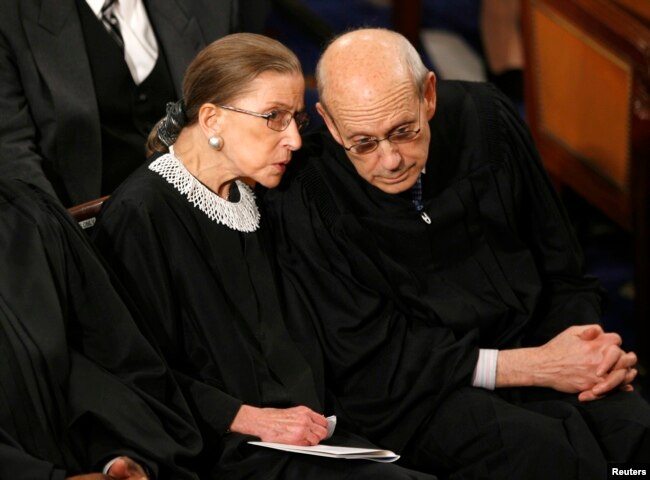 FILE - U.S. Supreme Court Associate Justices Ruth Bader Ginsburg and Stephen Bryer chat before then-President Barack Obama's address to a joint session of Congress on Capitol Hill in Washington, Feb. 24, 2009.