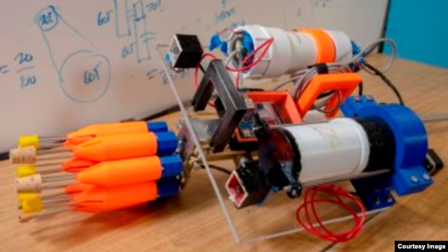 The robot contains eight orange spear tips, two small boxes just behind the carousel containing cameras, the electronics chamber behind the right camera, and a buoyancy chamber behind the left camera. (Worcester Polytechnic Institute)