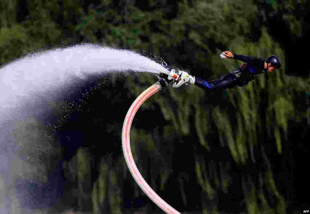 This photo shows a man performing on a water-propelled flyboard at Shenyang Olympic Park in Shenyang in China's northeastern Liaoning province.