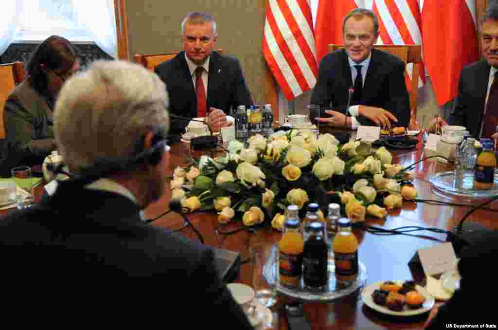 U.S. Secretary of State John Kerry listens to a translation of Polish Prime Minister Donald Tusk as he speaks at the outset of their meeting at the Chancery in Warsaw, Poland, on November 5, 2013.