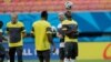 FILE - Cameroon's Pierre Webo, right, controls a ball during an official training session at the Arena da Amazonia in Manaus, Brazil, June 17, 2014. Many African youngsters dreaming of becoming wealthy football stars abroad face an uphill battle, a new report finds.
