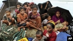 Rohingya Muslims who fled Myanmar to Bangladesh to escape religious violence, sit in a boat after being intercepted crossing the Naf River by Bangladeshi border authorities in Taknaf, Bangladesh. (file)