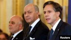 From left, Iraqi Prime Minister Haider al-Abadi, French Foreign Minister Laurent Fabius and U.S. Deputy Secretary of State Antony Blinken talk to reporters after a meeting of anti-Islamic State coalition members in Paris, June 2, 2015.