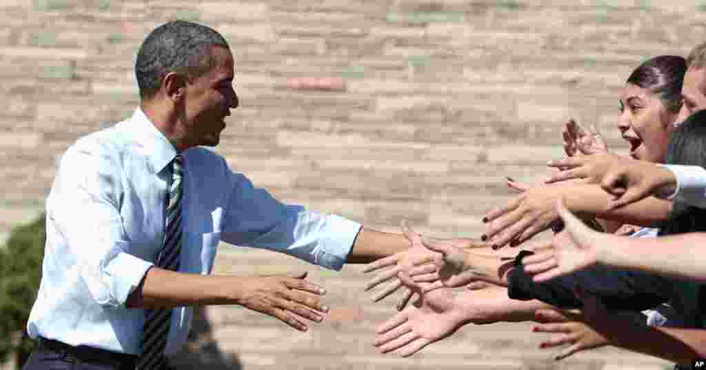 September 27: President Barack Obama shakes hands at Abraham Lincoln High School in Denver. (AP/Pablo Martinez Monsivais)