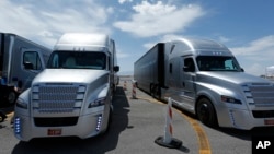 FILE - A Daimler Freightliner Inspiration self-driving truck is seen during a demonstration, May 6, 2015, in Las Vegas, Nevada.
