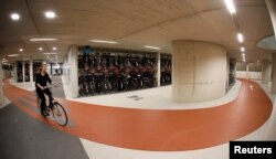 A cyclist rides her bike in the world's largest bike parking garage in Utrecht, Netherlands Aug. 21, 2017.