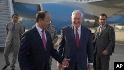 U.S. Secretary of State Rex Tillerson chats with Pakistani foreign office official, Sajid Bilal, as he arrives to the Nur Khan military airbase in Islamabad, Pakistan, Oct. 24, 2017. 