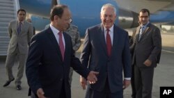 U.S. Secretary of State Rex Tillerson chats with Pakistani foreign office official, Sajid Bilal, as he arrives to the Nur Khan military airbase in Islamabad, Pakistan, Oct. 24, 2017. 