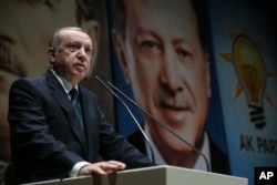 FILE - Turkey's President Recep Tayyip Erdogan delivers a speech at his ruling Justice and Development (AKP) Party conference in Ankara, March 30, 2018.