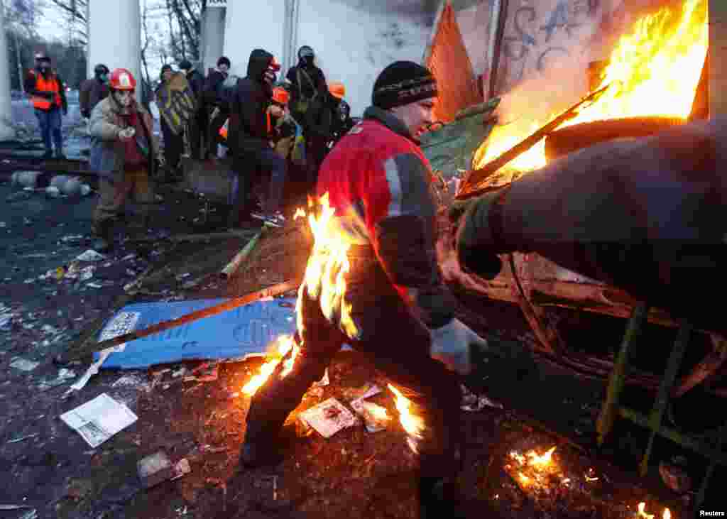 A pro-European integration protester catches fire during clashes with police in Kyiv. Ukrainian President Viktor Yanukovich named a top aide to organize peace talks with the opposition after violent clashes between police and protesters in the capital, but the opposition warned him not to play for time.