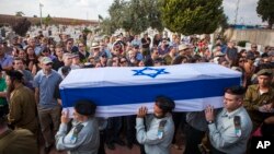 FILE - Israeli soldiers carry the coffin of Maj. Amotz Greenberg, 45, during his funeral in the Israeli city of Hod Hasharon, July 20, 2014. According to reports, Greenberg was killed fighting a group of militants who infiltrated Israel through a tunnel.