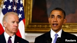 President Barack Obama speaks next to Vice President Joe Biden (L) at the White House in Washington, May 21, 2013.