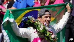 Helio Castroneves, of Brazil, celebrates after winning the Indianapolis 500 auto race at Indianapolis Motor Speedway, in Indianapolis, Indiana, May 30, 2021. 