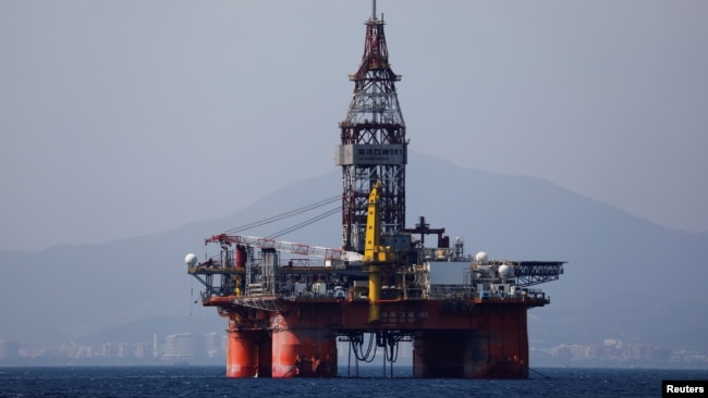 FILE - An oil platform operated by China National Offshore Oil Corporation (CNOOC) is seen in the sea off China's southernmost Hainan province, March 23, 2018.