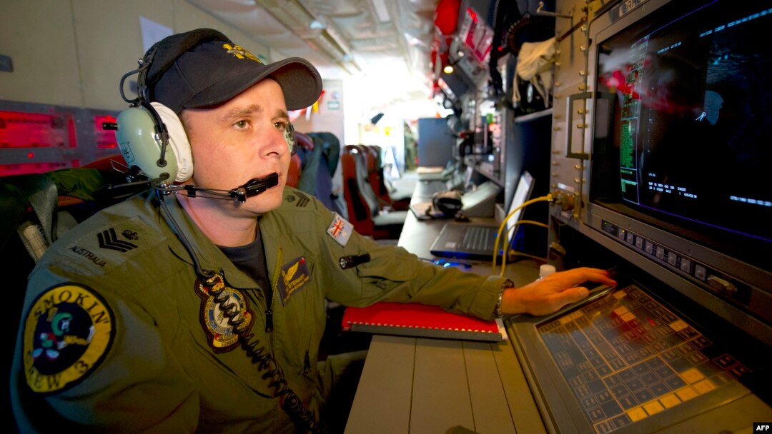 Royal Australian Air Force Airborne Electronics Analyst Flight Sergeant Tom Stewart from 10 Squadron watching a radar screen for signs of debris on board an AP-3C Orion over the Southern Indian Ocean during the search for missing Malaysian Airlines flight
