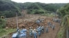 Police officers search for missing people at a landslide site caused by a heavy rain in Tsunagi town, Kumamoto prefecture, Japan