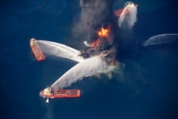 FILE - The Deepwater Horizon oil rig burns in the Gulf of Mexico following an explosion that killed 11 workers and caused the worst offshore oil spill in the nation's history, April 21, 2010.