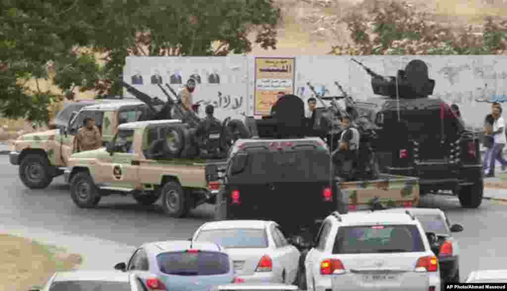 Vehicles with heavy artillery of the Tripoli joint security forces move closer to the parliament building after troops of Gen. Khalifa Haftar targeted Islamist lawmakers in parliament, Tripoli, May 18, 2014.